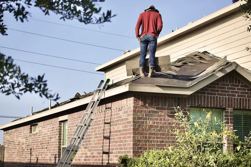 Professional roofer working on a residential roof in Grand Peninsula